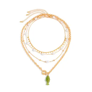 Gros plan détaillé d'un collier doré multi-rangs avec perles et pendentif poisson vert