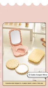 Detailed view of biscuit-shaped folding travel mirror and comb set in pink and yellow colors