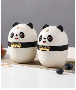 Detailed view of two cute panda-shaped automatic pop-up toothpick holders on table