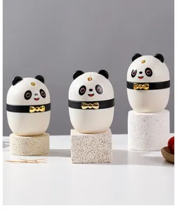 Close-up view of creative panda automatic toothpick holders on decorative stone pedestals