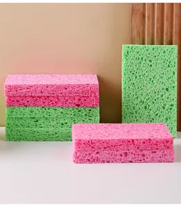 Detailed macro view showing the porous texture of pink and green cellulose cleaning sponges