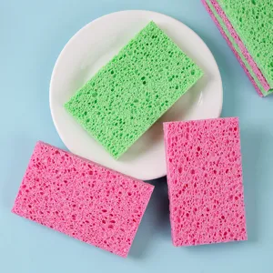 Eco-friendly wood pulp cotton cleaning sponges in vibrant pink and green colors