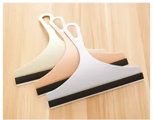 Detail of three colorful plastic glass squeegees for bathroom and tile cleaning.