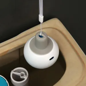 Detailed view of a hanging plastic toilet cleaning ball installed inside a toilet tank