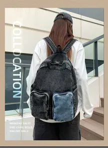 Rear view of a stylish grey denim backpack with blue pocket worn by an urban model