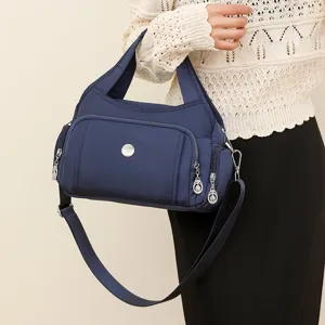 Fashionable blue waterproof nylon handbag on shoulder with multi-functional zipper pockets