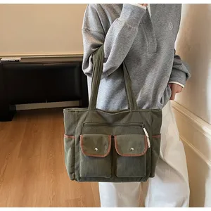 Close-up view of a large green corduroy tote bag for women in a professional lifestyle setting