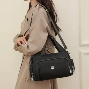 Asian model wearing a stylish black waterproof nylon shoulder bag with multiple zippers