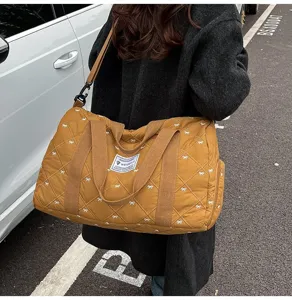 Quilted travel duffel bag with bow pattern, casual brown weekender bag for women.