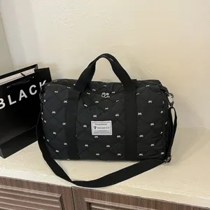 Black quilted travel duffel bag with white bow pattern, lightweight gym sports bag