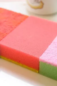 Macro detail view showing the porous texture of double-sided kitchen cleaning sponges