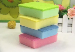 Macro view of stacked colorful double-sided cleaning sponges for kitchen dishwashing use
