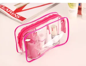 Detailed view of the transparent PVC cosmetic bag with pink trim and sturdy zipper