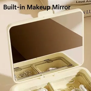 Eleganter tragbarer Schmuckkasten in Creme mit Make-up-Spiegel und transparenten Fächern