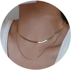 Close-up of a stylish double-layered gold snake chain and thin link necklace