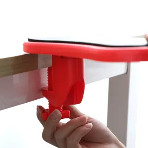 Ergonomic red rotating computer desk armrest with integrated mouse pad and screw clamp.