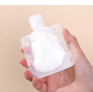 Close-up of a hand holding a portable refillable travel squeeze pouch with lotion