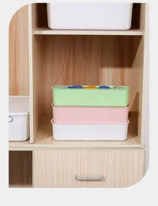 Multi-colored stackable plastic storage bins for drawer organization in wooden cabinet