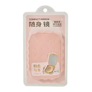 Specchio compatto portatile rosa a forma di biscotto con pettine integrato per il trucco