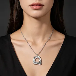 Detailed macro view of the silver geometric hollow pendant with hammered texture on model