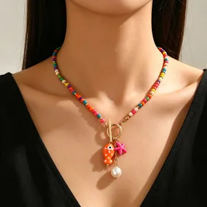 Detail shot of bohemian beaded necklace featuring ceramic fish and starfish pendants