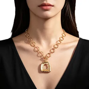 Vintage gold chunky chain necklace with large irregular geometric pendant on model