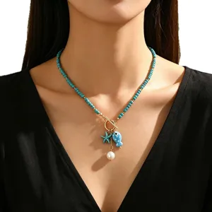 Bohemian turquoise beaded necklace with blue ceramic fish, starfish and pearl charms