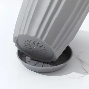 Duurzame grijze plastic bloempot met drainagegaten en bijpassende schotel voor planten.