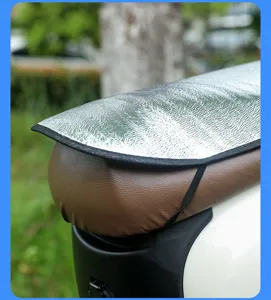 Close-up of reflective aluminum foil sunshade mat on a brown leather motorcycle seat