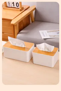 Detailed view of minimalist white tissue boxes with bamboo lids in a home setting