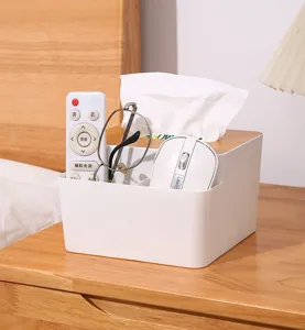 Multifunctional white tissue box organizer holding remotes and mouse on nightstand