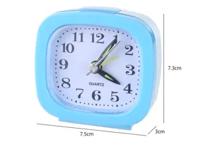 Detailed view of a blue square candy-colored alarm clock with 7.5x7.3cm dimensions