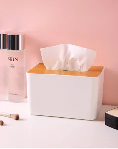 Minimalist white desktop tissue box with a natural wood lid shown in a vanity setting.