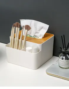 Detail of a white multifunctional tissue box and desk organizer with wooden lid.