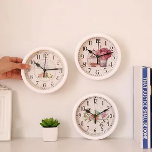 Vintage round wall clocks with floral designs and white frames for home interior decor