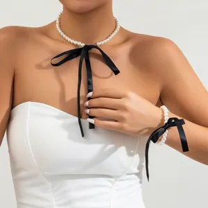 Elegant French retro pearl necklace and bracelet jewelry set featuring black ribbon bows
