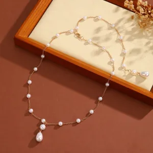 Exquisite gold chain necklace featuring multiple round pearls and teardrop-shaped tassels
