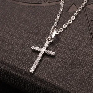 High-quality detailed shot of a silver hip-hop cross necklace with sparkling zircons
