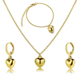 Polished gold heart jewelry set including necklace bracelet and earrings details