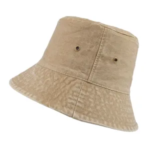 Detailed macro view of a washed khaki denim bucket hat with metal eyelets.