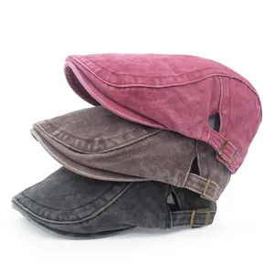 Stack of three vintage washed cotton beret caps in red, brown, and grey distressed colors