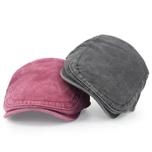 Detailed macro view of vintage washed cotton beret flat caps in burgundy and charcoal grey