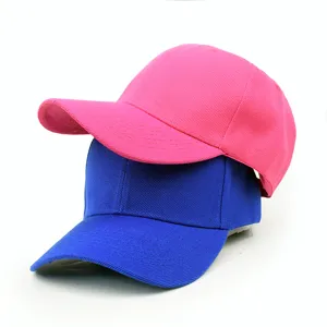Stacked plain baseball caps in bright pink and blue colors showing fabric texture