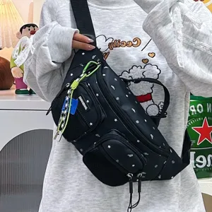 Detail of black nylon star print chest bag with multiple zipper pockets for women