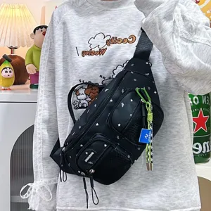 Detailed view of black nylon chest bag with star patterns and neon zipper pull