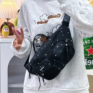 Close-up of a black nylon waist bag with star patterns and multiple zippered pockets
