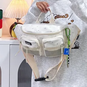 Detail view of a white nylon chest bag with star patterns and mesh pockets.