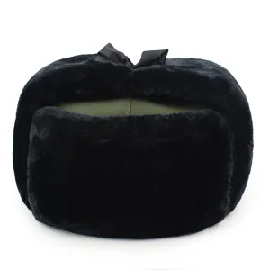 Detail of a vintage black faux fur Lei Feng hat with an olive green top and bow decoration.