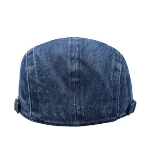 Detailed back view of a vintage blue denim flat cap featuring adjustable side buckles