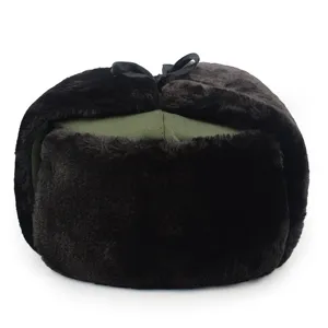 Detail view of a classic winter ushanka hat with olive green crown and thick black faux fur.